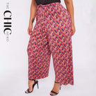 Plus size female model in sunflower print abstract wide-leg drawstring palazzo pants, stretchy opaque crease-resistant fabric, sizes UK 8–32